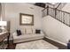 Cozy sitting area featuring a comfortable sofa, decorative mirror, adjacent to the staircase at 3059 E Parkview Dr, Gilbert, AZ 85295