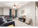 Cozy living room featuring a plush grey couch, ceiling fan, and bright decor for a comfortable living space at 3059 E Parkview Dr, Gilbert, AZ 85295