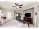 A beautifully appointed main bedroom featuring a large bed, ceiling fan and a view of the staircase and hallway at 3059 E Parkview Dr, Gilbert, AZ 85295