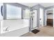 Bright bathroom featuring a soaking tub and a glass enclosed shower at 31269 N Cavalier Dr, San Tan Valley, AZ 85143