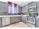 Well-equipped kitchen with gray cabinets, stainless steel appliances and gray backsplash at 31269 N Cavalier Dr, San Tan Valley, AZ 85143