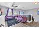 Bright living room with purple sofas, ceiling fan, and gray walls at 31269 N Cavalier Dr, San Tan Valley, AZ 85143