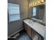Bathroom with a modern vanity, decorative mirror, updated lighting and mosaic backsplash at 318 N Pinal Dr, Apache Junction, AZ 85120