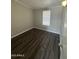 Cozy bedroom featuring neutral walls, wood floors, and a bright window at 318 N Pinal Dr, Apache Junction, AZ 85120