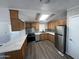 Modern kitchen featuring wood cabinets, stainless steel appliances, and sleek countertop at 318 N Pinal Dr, Apache Junction, AZ 85120
