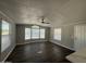Bright living room featuring neutral walls, sleek wood floors, ceiling fan, and plentiful natural light at 318 N Pinal Dr, Apache Junction, AZ 85120