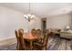 Charming dining room featuring a wood table and chairs with an ornate chandelier above at 35729 N 32Nd Ave, Phoenix, AZ 85086