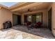 Covered patio with stone flooring, ceiling fan, and outdoor seating area at 35729 N 32Nd Ave, Phoenix, AZ 85086