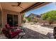 Covered patio with stone flooring, ceiling fan, and outdoor seating area at 35729 N 32Nd Ave, Phoenix, AZ 85086