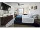 Bright bedroom with ceiling fan, dresser, and natural light streaming through the window at 4050 E Cactus Rd # 107, Phoenix, AZ 85032