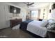Cozy bedroom with ceiling fan, large dresser, and natural light from the window at 4050 E Cactus Rd # 107, Phoenix, AZ 85032