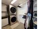 Organized closet space featuring a stacked washer and dryer, along with ample hanging storage for clothing at 4050 E Cactus Rd # 107, Phoenix, AZ 85032