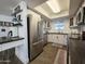 Open kitchen design with stainless steel appliances, modern countertops, and skylight, creating a bright and functional space at 4050 E Cactus Rd # 107, Phoenix, AZ 85032