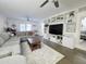 Bright living room featuring a plush gray sectional sofa, modern built-ins, and stylish decor, perfect for relaxing at 4050 E Cactus Rd # 107, Phoenix, AZ 85032