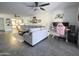 Spacious living room with a comfortable gray sofa, adjacent to an organized workspace with a pink gaming chair at 4050 E Cactus Rd # 107, Phoenix, AZ 85032