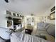 Inviting living space with a large sectional sofa, contemporary shelving, and seamless flow into the kitchen area at 4050 E Cactus Rd # 107, Phoenix, AZ 85032