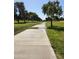 Scenic paved path winding through a lush green space with mature trees at 4050 E Cactus Rd # 107, Phoenix, AZ 85032