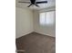 Cozy bedroom with neutral carpet, a ceiling fan, and a window at 4502 N 50Th Ave, Phoenix, AZ 85031