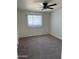 Carpeted bedroom with a ceiling fan and window for natural light at 4502 N 50Th Ave, Phoenix, AZ 85031