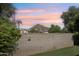 A fenced backyard with trees, mountain views and a beautiful sunset at 4525 N 66Th St # 1, Scottsdale, AZ 85251