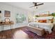 Sunlit bedroom with hardwood floors, shuttered windows, and neutral-toned decor and furnishings at 4525 N 66Th St # 1, Scottsdale, AZ 85251