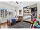 Bright bedroom featuring a wooden bed frame, shuttered windows and custom closet storage at 4525 N 66Th St # 1, Scottsdale, AZ 85251