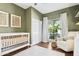 Cozy Bedroom featuring neutral decor, a white crib, a comfortable chair, and plenty of natural light at 4525 N 66Th St # 1, Scottsdale, AZ 85251