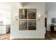 Hallway featuring framed paintings and wall sconces, transitioning into adjacent rooms at 4525 N 66Th St # 1, Scottsdale, AZ 85251