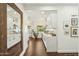 Stylish kitchen featuring white cabinets, marble countertops, stainless steel appliances, and dark hardwood floors at 4525 N 66Th St # 1, Scottsdale, AZ 85251