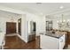 Open concept kitchen featuring a stainless steel refrigerator, island with seating, and dark wood flooring at 4525 N 66Th St # 1, Scottsdale, AZ 85251
