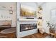 Modern living room with a cozy fireplace, a mounted flatscreen TV, and decorative shelving at 4525 N 66Th St # 1, Scottsdale, AZ 85251