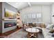 Bright and airy living room featuring a fireplace, large screen TV, and a comfortable neutral-toned sectional at 4525 N 66Th St # 1, Scottsdale, AZ 85251