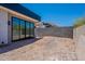 Unfinished backyard with block wall and sliding glass doors to modern home at 5145 N Ascent Dr, Scottsdale, AZ 85251