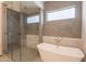 Bathroom with free standing tub, walk in shower and light-filled window at 5145 N Ascent Dr, Scottsdale, AZ 85251