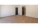 Bedroom features wood flooring and neutral walls with black doors leading to the closet and hallway at 5145 N Ascent Dr, Scottsdale, AZ 85251