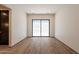 Bright bedroom with sliding glass door, hardwood floors, and access to hall at 5145 N Ascent Dr, Scottsdale, AZ 85251