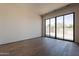 Bright bedroom with sliding glass doors to patio, and light hardwood flooring at 5145 N Ascent Dr, Scottsdale, AZ 85251