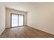 Spacious bedroom with natural light from sliding glass door, and rich hardwood flooring at 5145 N Ascent Dr, Scottsdale, AZ 85251