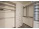 Walk in closet with custom shelving and built in drawers for optimal storage and organization at 5145 N Ascent Dr, Scottsdale, AZ 85251