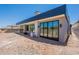Modern home exterior with large sliding glass doors and spacious, unfinished backyard at 5145 N Ascent Dr, Scottsdale, AZ 85251