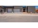 Striking new build featuring a three-car garage with modern gray tones and contemporary design at 5145 N Ascent Dr, Scottsdale, AZ 85251