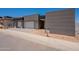 Modern home with a three-car garage, gray tones, clean lines, and fresh desert landscaping at 5145 N Ascent Dr, Scottsdale, AZ 85251