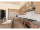 Kitchen features custom wood cabinets, stainless steel appliances, and a professional grade gas range and oven at 5145 N Ascent Dr, Scottsdale, AZ 85251