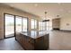 Open concept kitchen with large island, fireplace and views of the outside through floor to ceiling windows at 5145 N Ascent Dr, Scottsdale, AZ 85251