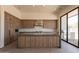 Modern kitchen with a large island, stainless steel appliances, and a separate outdoor cooking area at 5145 N Ascent Dr, Scottsdale, AZ 85251