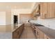 Spacious kitchen features modern appliances, custom wood cabinets, and a large gray quartz countertop at 5145 N Ascent Dr, Scottsdale, AZ 85251