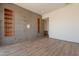 Open concept living room showcases beautiful hardwood floors, tiled accent wall, and built in shelves at 5145 N Ascent Dr, Scottsdale, AZ 85251