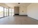 Spacious living room with floor-to-ceiling windows, stone fireplace, and a contemporary lighting fixture at 5145 N Ascent Dr, Scottsdale, AZ 85251