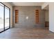 Bright living room with sliding glass door, hardwood floors, tiled accent wall with built-in shelves at 5145 N Ascent Dr, Scottsdale, AZ 85251