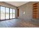 Spacious living room featuring sliding glass door, tiled wall with built-in shelves, and hardwood floors at 5145 N Ascent Dr, Scottsdale, AZ 85251